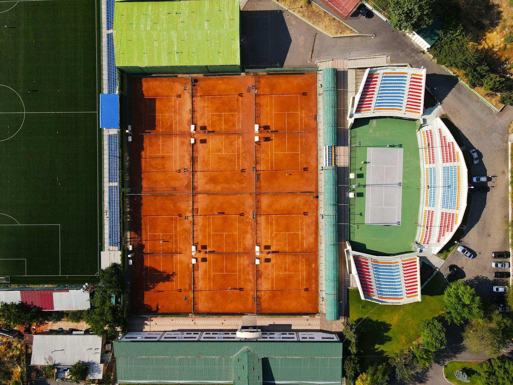 Aerial photo showcasing clay tennis courts and adjacent soccer field in Yerevan, Armenia.