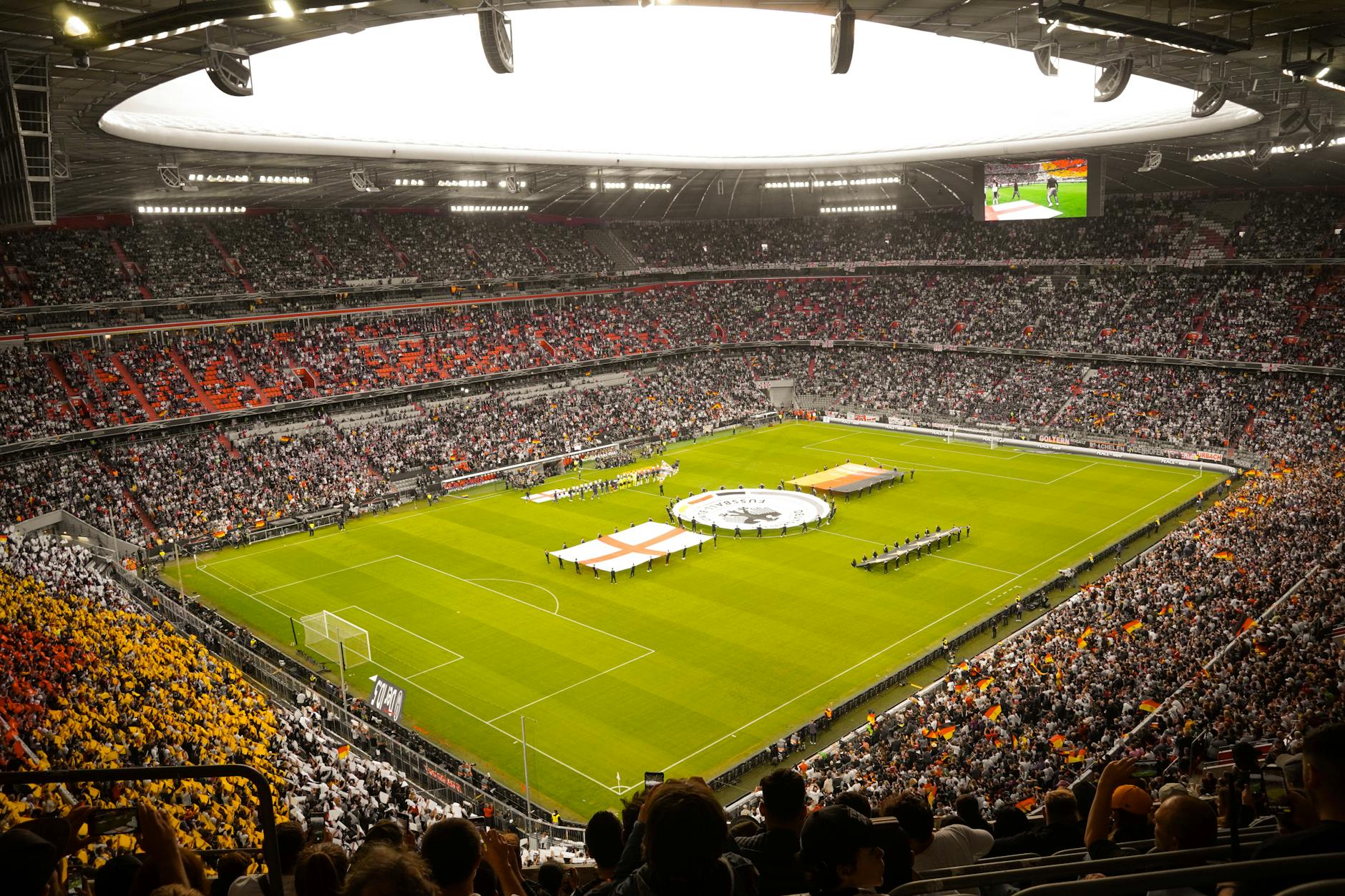 Captivating view of a soccer match at Munich's iconic Allianz Arena, filled with excited fans.